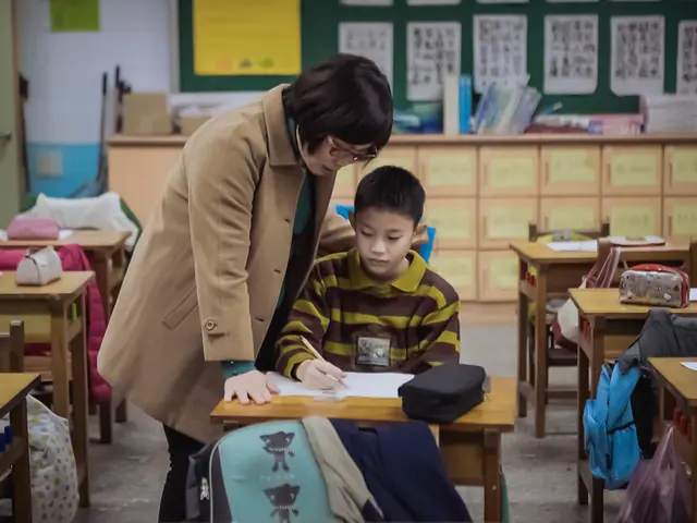 in the picture there is a woman and a boy sitting on a chair,woman is standing a boy is writing on...